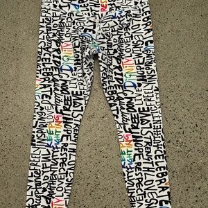 Athleta Elation Train 7/8 Crop Pride Rainbow Graffiti leggings.